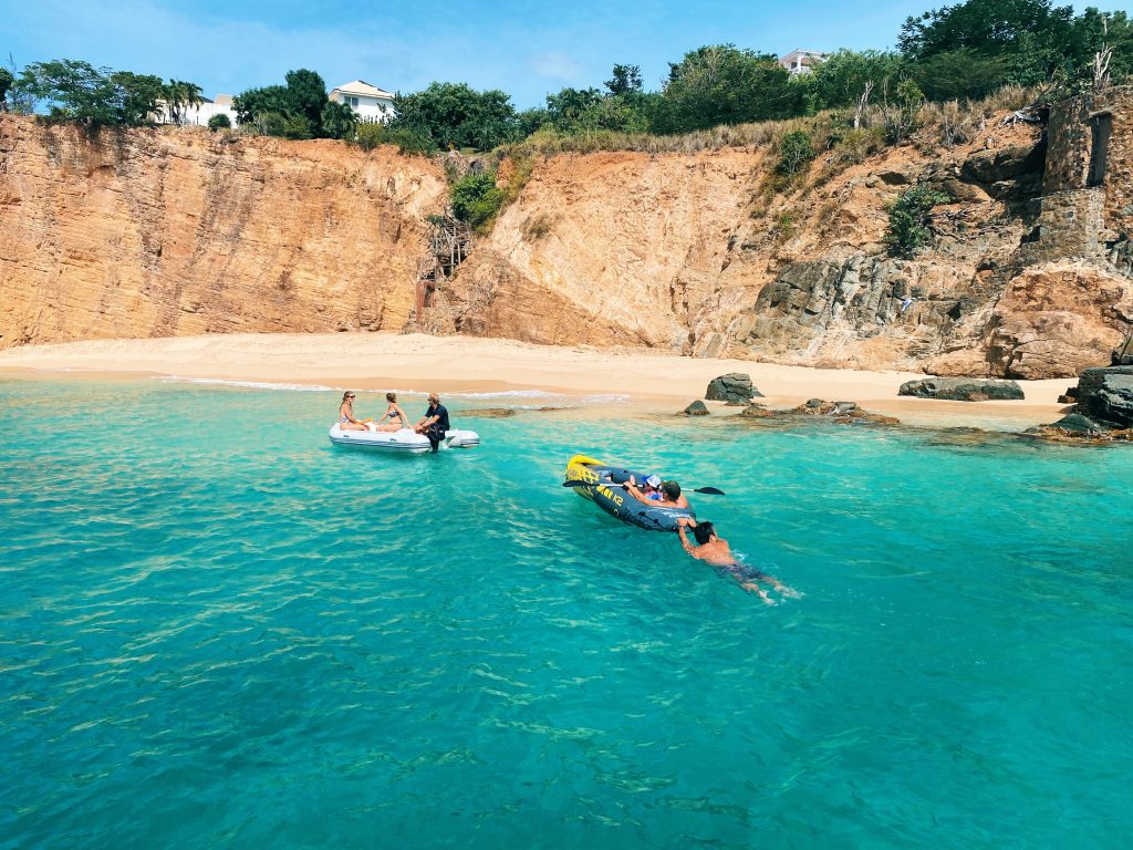 Guests on the dinghy with Captain Max,  towing other guests on the Kayak