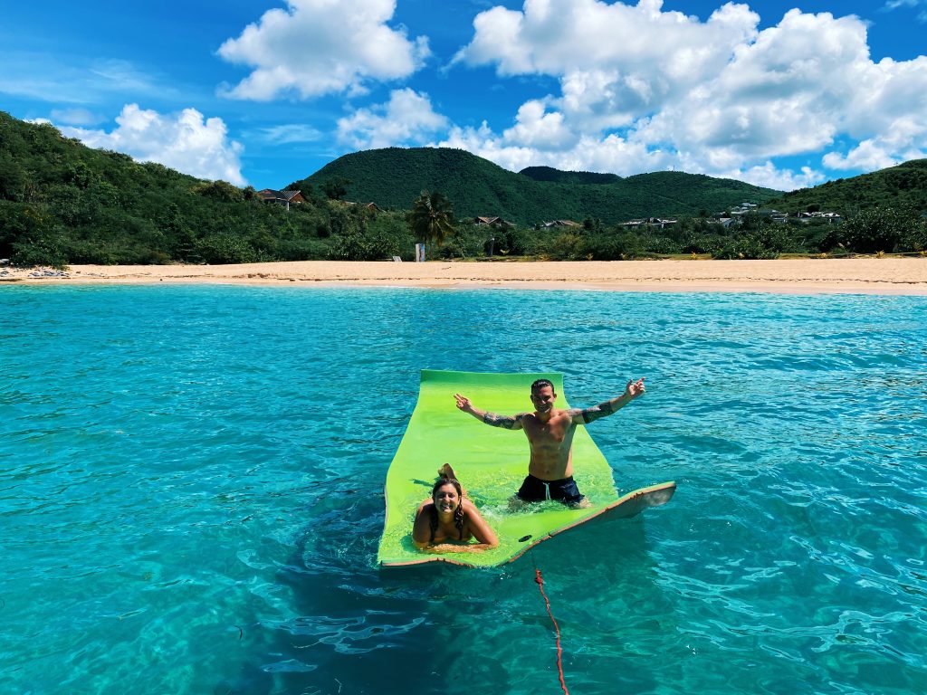 A couple enjoying the privacy in Happy Bay on our floating mat.