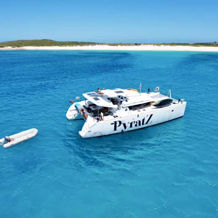 Galaxy motor catamaran anchored off the coast of Scrub Island, Anguilla with its perfect white sand beach in the background