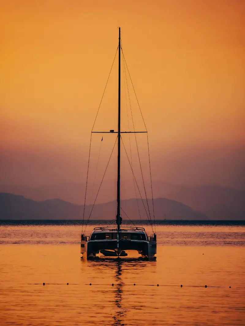 Sailing catamaran ashore during a sunset in St Martin