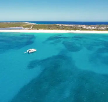 Drone view of a motor catamaran anchored near Scrub Island, in Anguilla, during a boat charter in Anguilla