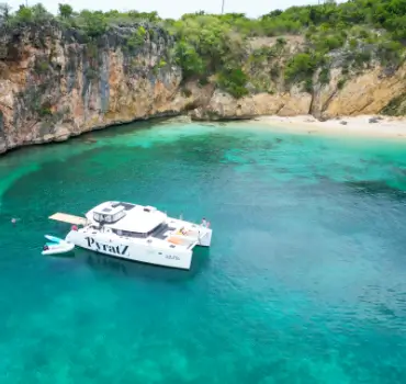 Motor catamaran from Pyratz anchored near a remote beach in Anguilla