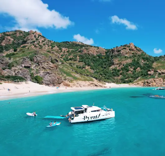 Motor catamaran from Pyratz anchored on a beach near the island of St Barts