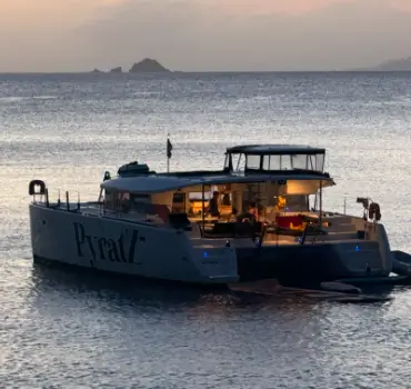 Motor catamaran from Pyratz anchored at a beach in Anguilla after the sunset