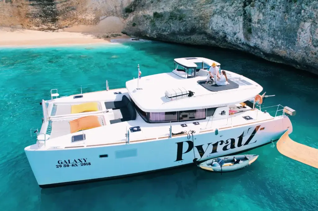 Luxury Pyratz yacht anchored in a secluded cove with a couple on deck.