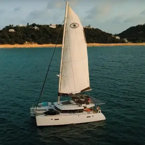 Sailing catamaran Amari sailing around the Caribbean island of St Martin as seen from a drone