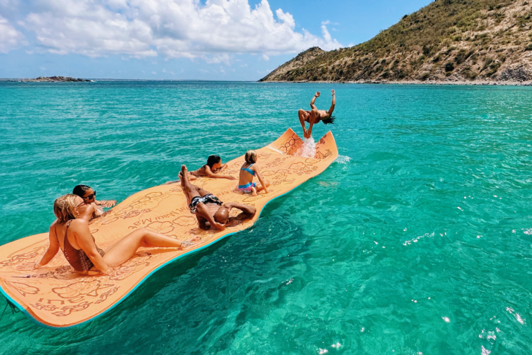 Guy jumping on the water from a floating mat