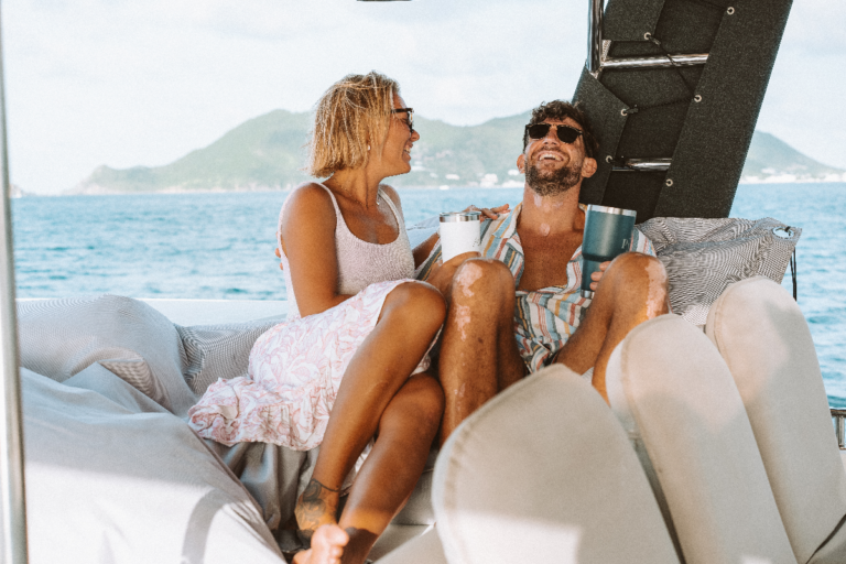 Couple relaxing on the deck of our sailing catamaran