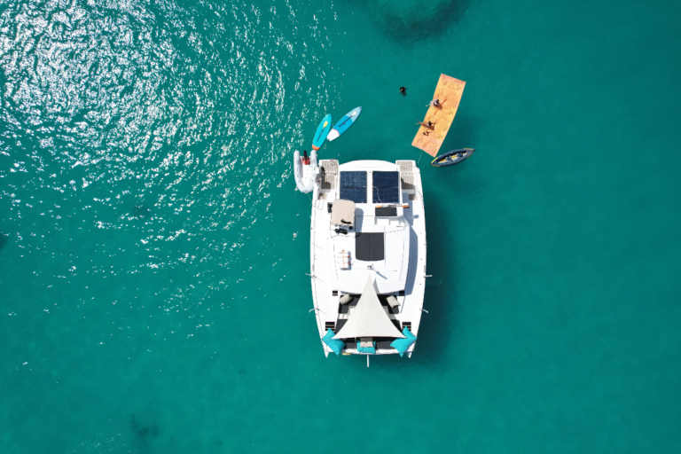 Zenital drone picture of one of our motor catamarans during a shared boat charter