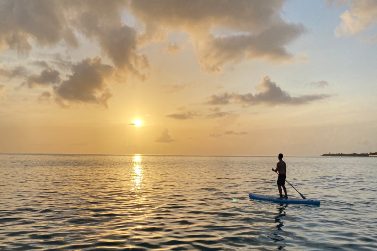 Person on a SUP board paddling during the sunset in Anguilla