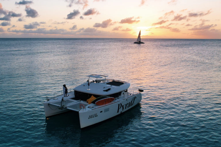 Motor catamaran as seen from a drone shot during the sunset