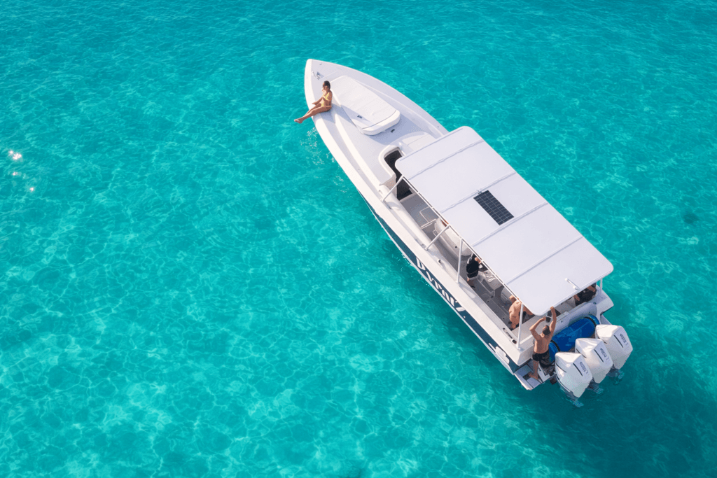 Guest enjoying turqoise blue water from our Let's Do It motorboat in St Martin