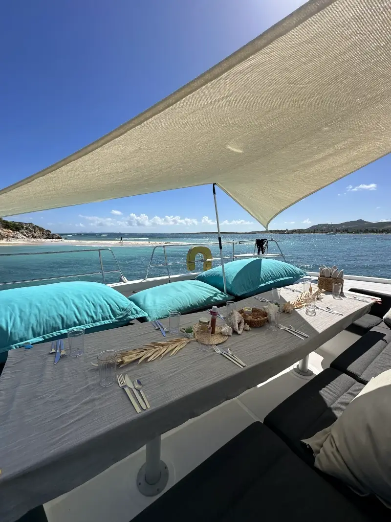 Green Cay from the outdoor deck of our luxury catamarans with the lunch set on the table